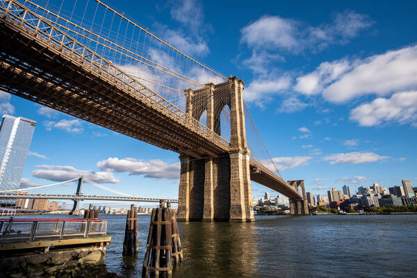 New York City - USA - Oct 18 2019: Brooklyn Bridge in daylight view from Lower East Side waterfront