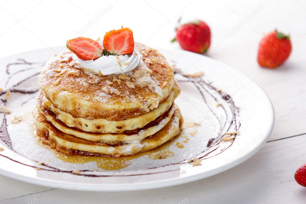homemade pancake with honey and strawberry topping