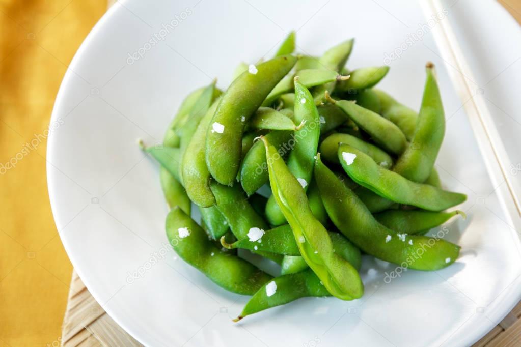 japanese food edamame nibbles, boiled green soy beans