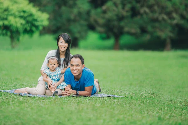 Счастливая семья лежит в траве — стоковое фото