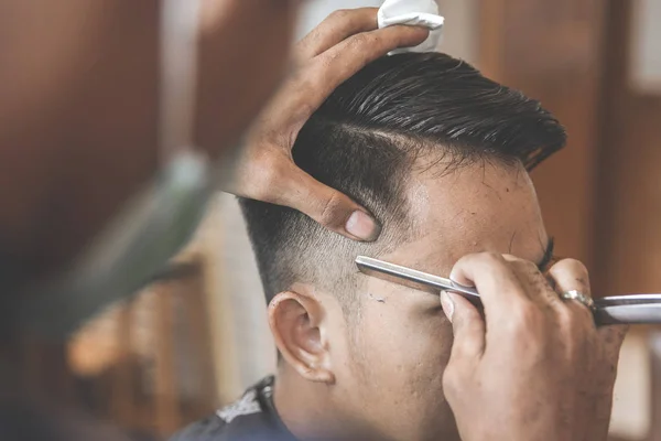 man getting his hair cut