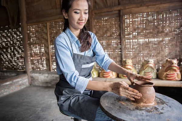 asian woman making vase