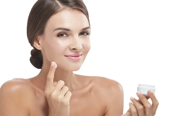 Beautiful woman applying some facial cream — Stock Photo, Image