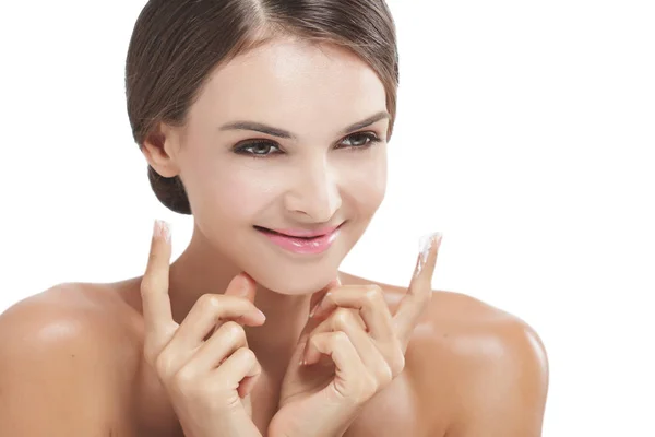 Beautiful woman smiling with some facial cream on her fingers — Stock Photo, Image