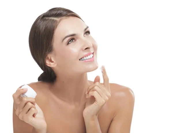 Beautiful young woman smiling while take some facial cream — Stock Photo, Image