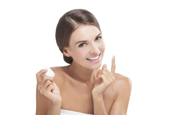 Beautiful young woman smiling while take some facial cream — Stock Photo, Image