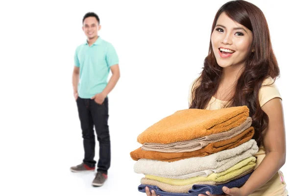 Asian man and woman holding towels pile — Stock Photo, Image