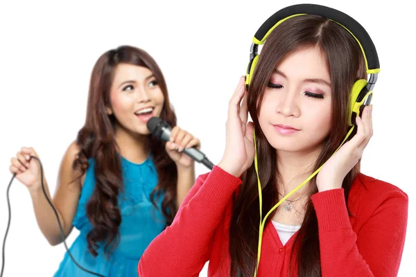 Woman with headphones and singing female — Stock Photo, Image