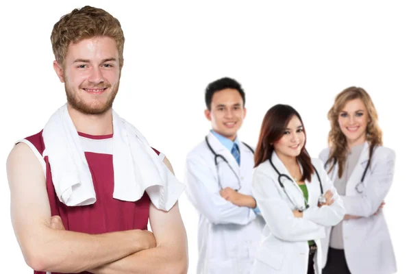 Man with towel and smiling doctors — Stock Photo, Image