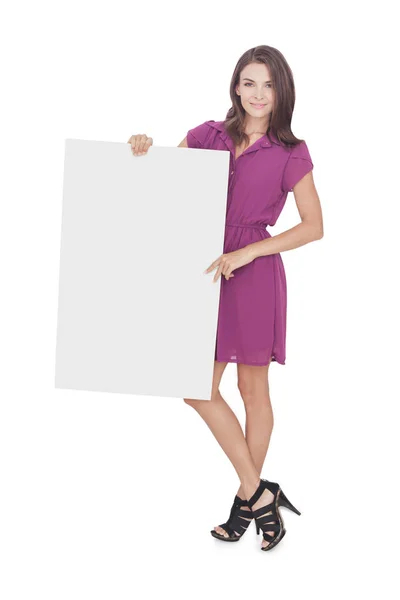 Beautiful woman wearing casual dress holding blank board — Stock Photo, Image