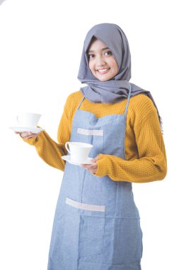 Waitress with head scarf serving coffee clipart