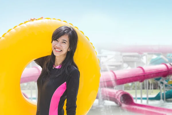 Mujer con tubo inflable en la piscina — Foto de Stock