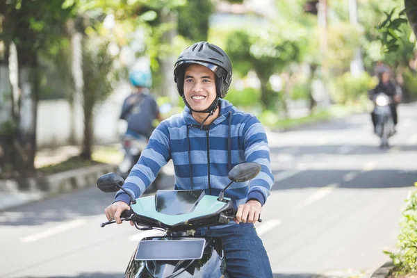 Happy man riding on motorbike — Stock Photo, Image