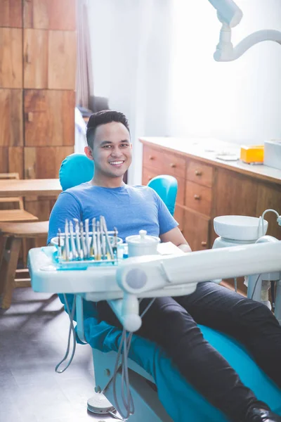 Pacjent siedzi w Fotel dentystyczny — Zdjęcie stockowe