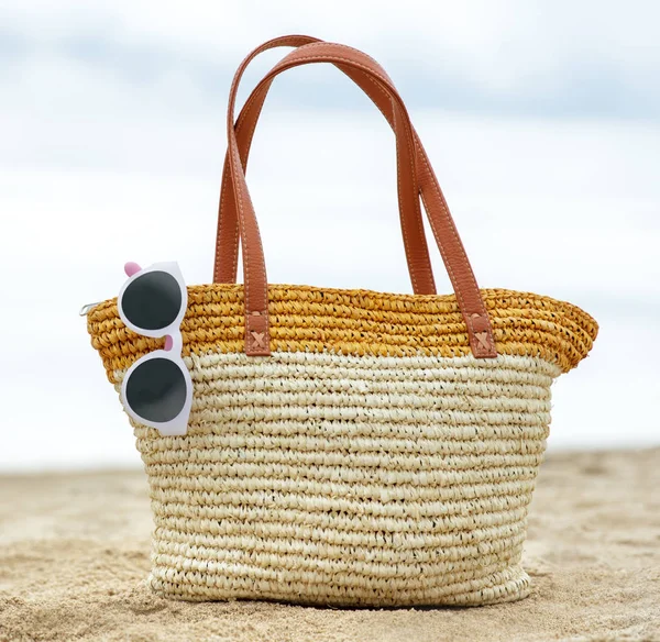 Gafas de sol y bolso en la arena para el concepto de verano — Foto de Stock