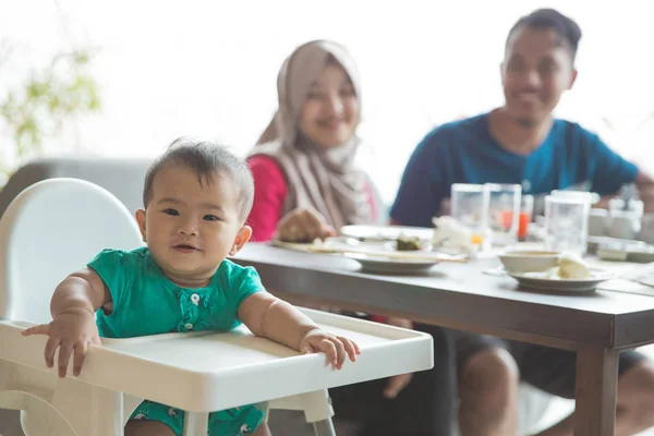 cute girl sitting on high chair