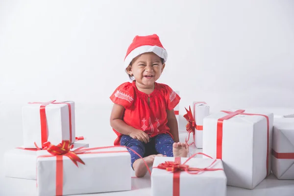 Baby with gift boxes sitting on floor — Stock Photo, Image