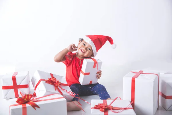 Baby with gift boxes sitting on floor — Stock Photo, Image