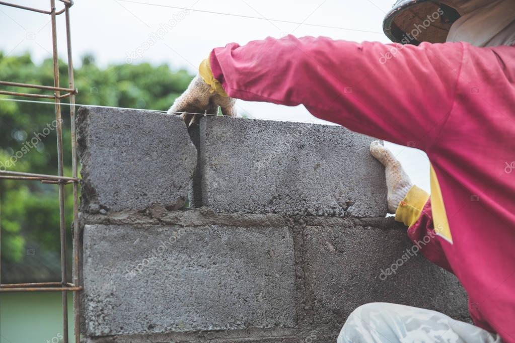 installing cement bricks on construction site