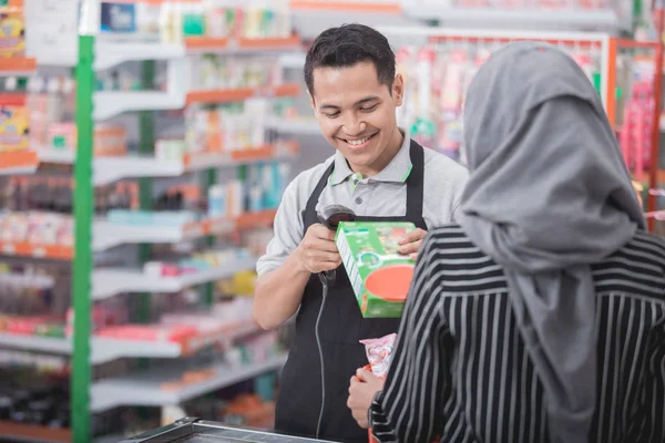 Male shopkeeper scanning product barcode — Stock Photo, Image