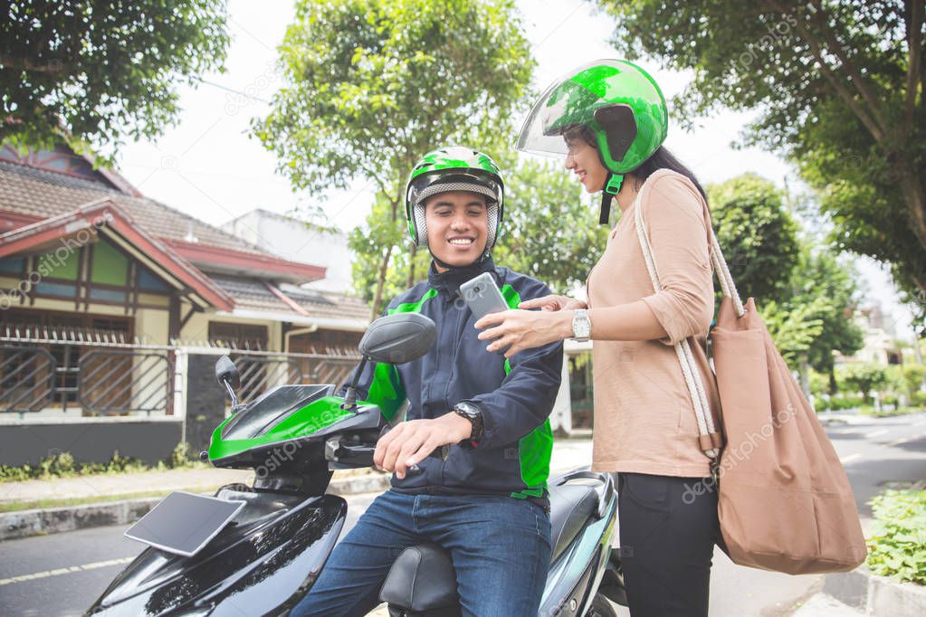woman ordering commercial motorcycle taxi
