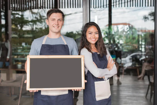 two cafe owner with blackboard