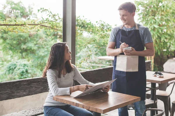 customer ordering toward waitress