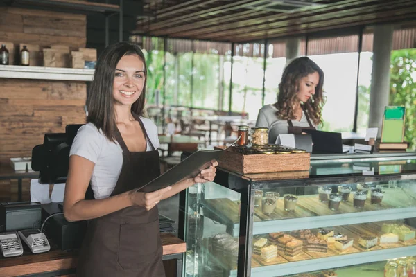 Waitress with menu in her hand — Stock Photo, Image