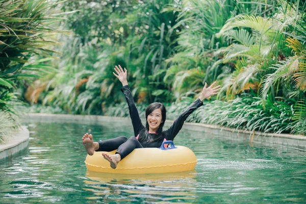 Woman raising arms in swimming circle — Stock Photo, Image