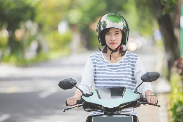 Woman riding motorbike