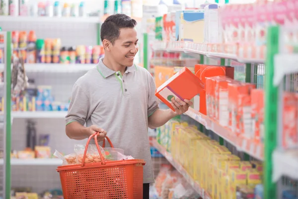 Young man looking at a product — Stock Photo, Image