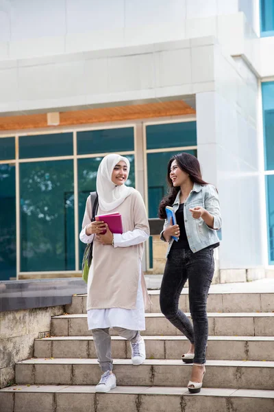 students friends walking on campus