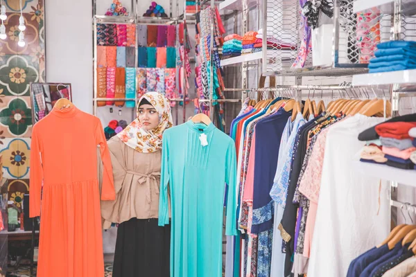 Woman choosing between two clothes — Stock Photo, Image