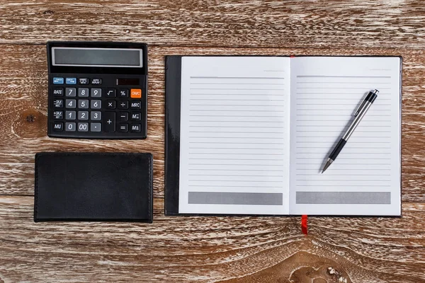 Calculadora e notebook para negócios simular em backgroun de madeira — Fotografia de Stock