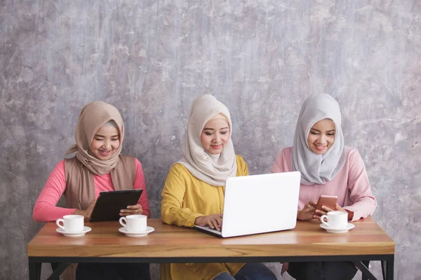 Tres hermanos con hijab están ocupados en su propio gadget — Foto de Stock