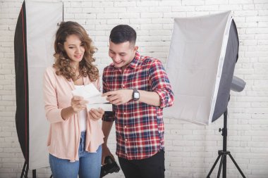 Onun fotoğraf onun modeli için baskı sonucu ile ilgilenen fotoğrafçı