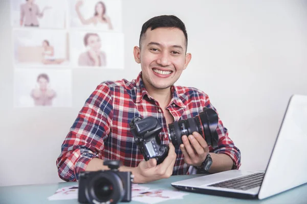 Young photographer attaching the camera lens to camera body — Stock Photo, Image