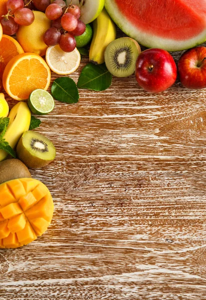 Fresh mixed fruits on  wooden background — Stock Photo, Image