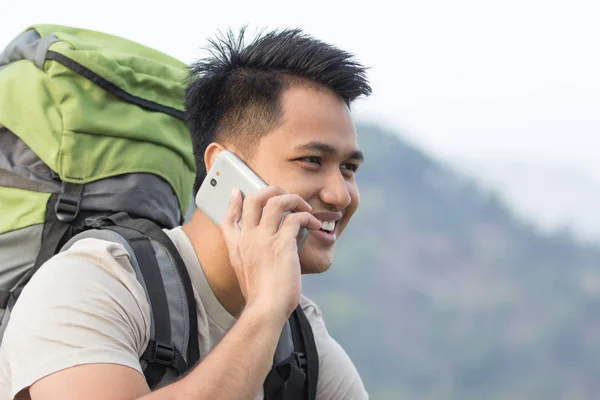 Excursionista masculino usando teléfono móvil — Foto de Stock