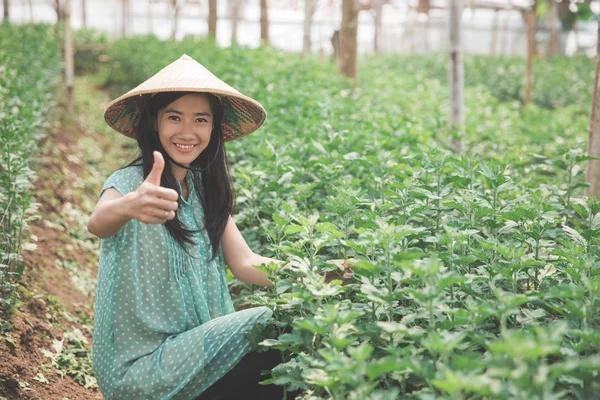 female farmer showing thumb up