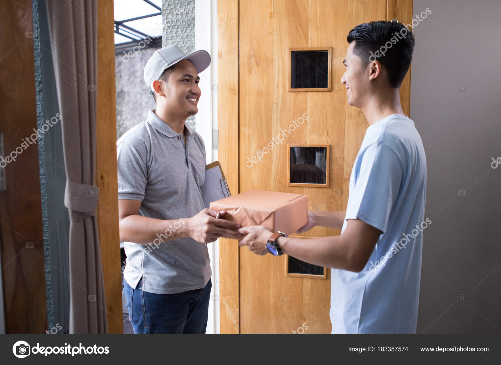 Man receiving a package Stock Photo by ©odua 183357574