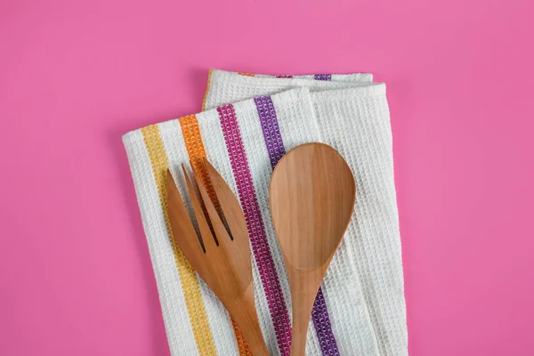 Wooden serving spoon and fork with napkin — Stock Photo, Image