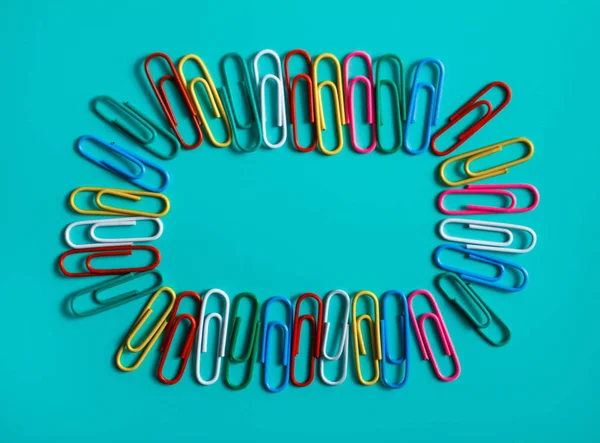 Colorful paperclip on blue pastel background — Stock Photo, Image