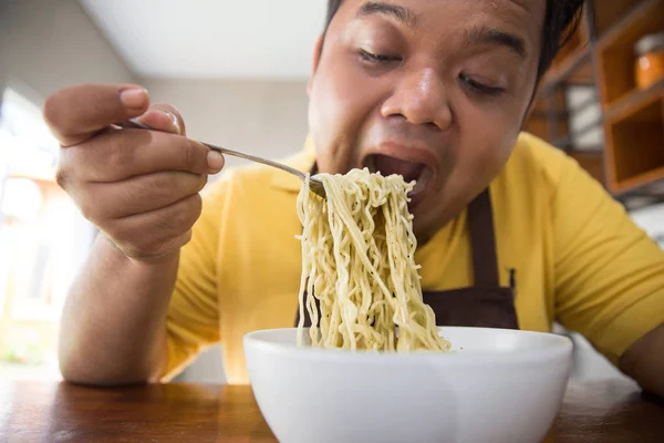 Young fat man eating