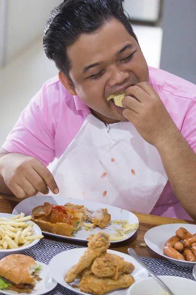 Young fat man eating Stock Photo