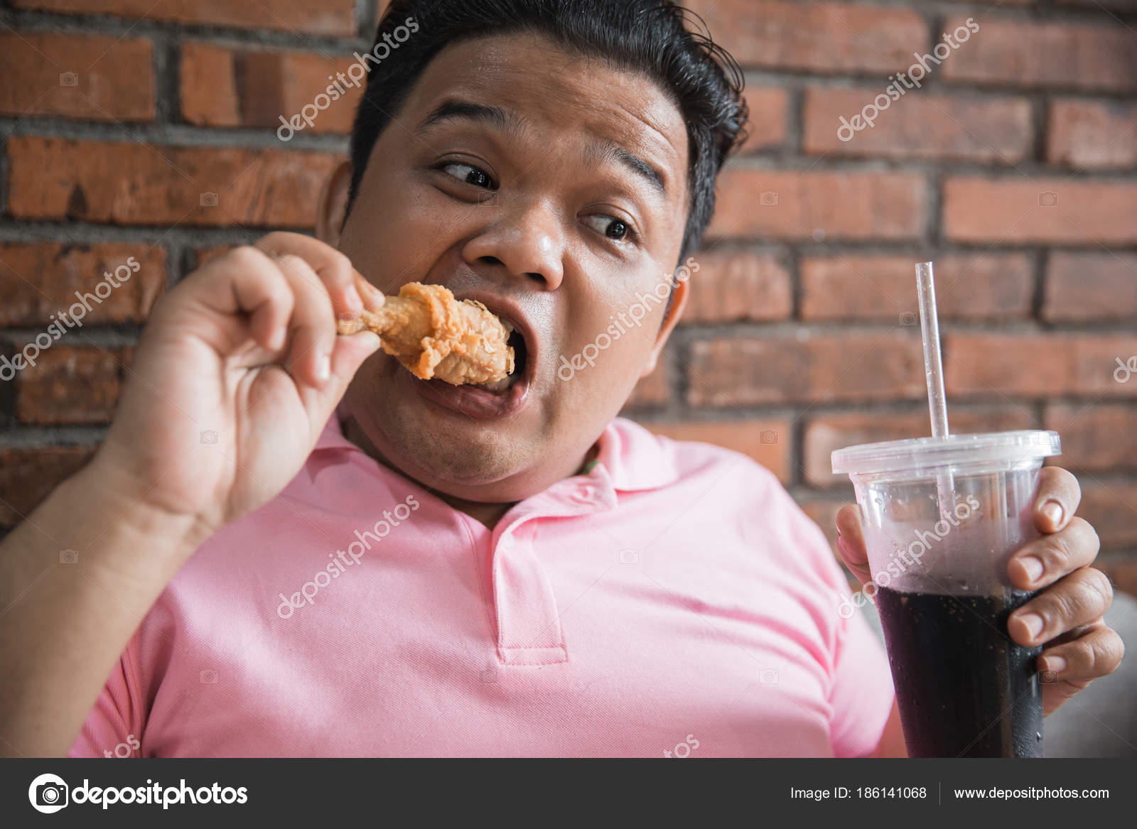 Man eating fried chicken Stock Photo by ©odua 186141068