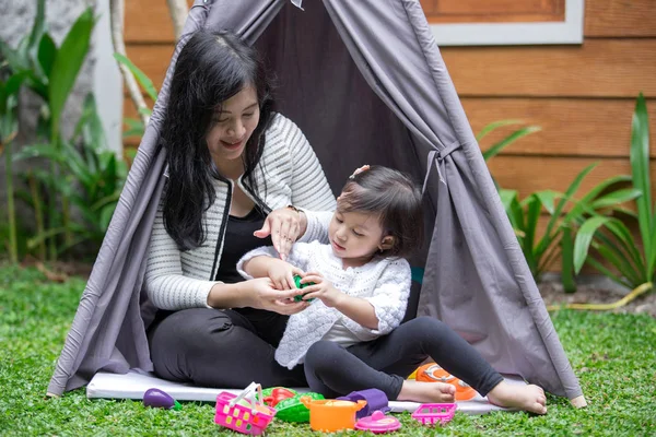 Play toys with mother in tent — Stock Photo, Image