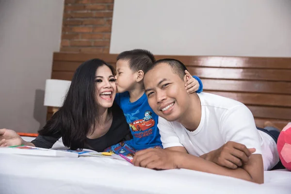 Aziatische en gelukkige familie in het bed — Stockfoto
