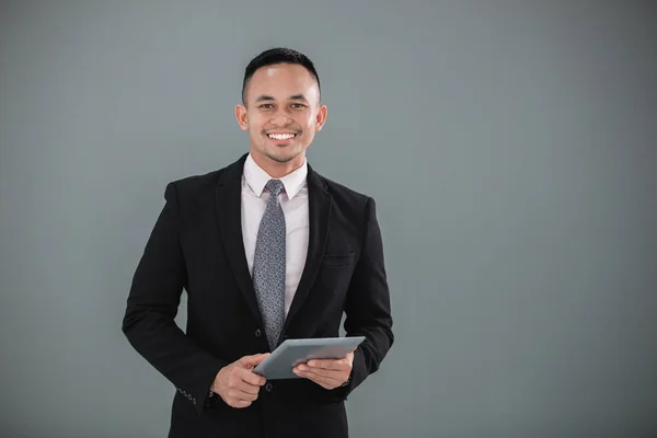 Young adult businessman with tablet — Stock Photo, Image