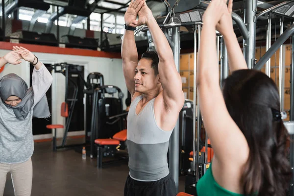 Asian man together warm up shoulders for working out